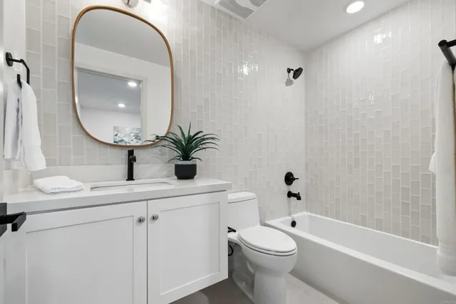 a bathroom with a toilet a sink and a mirror