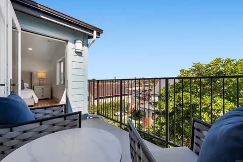 a balcony with table and chairs