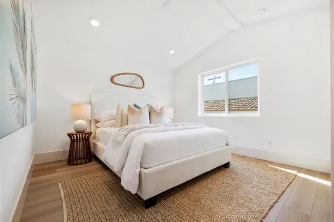 a bedroom with a bed and lamps