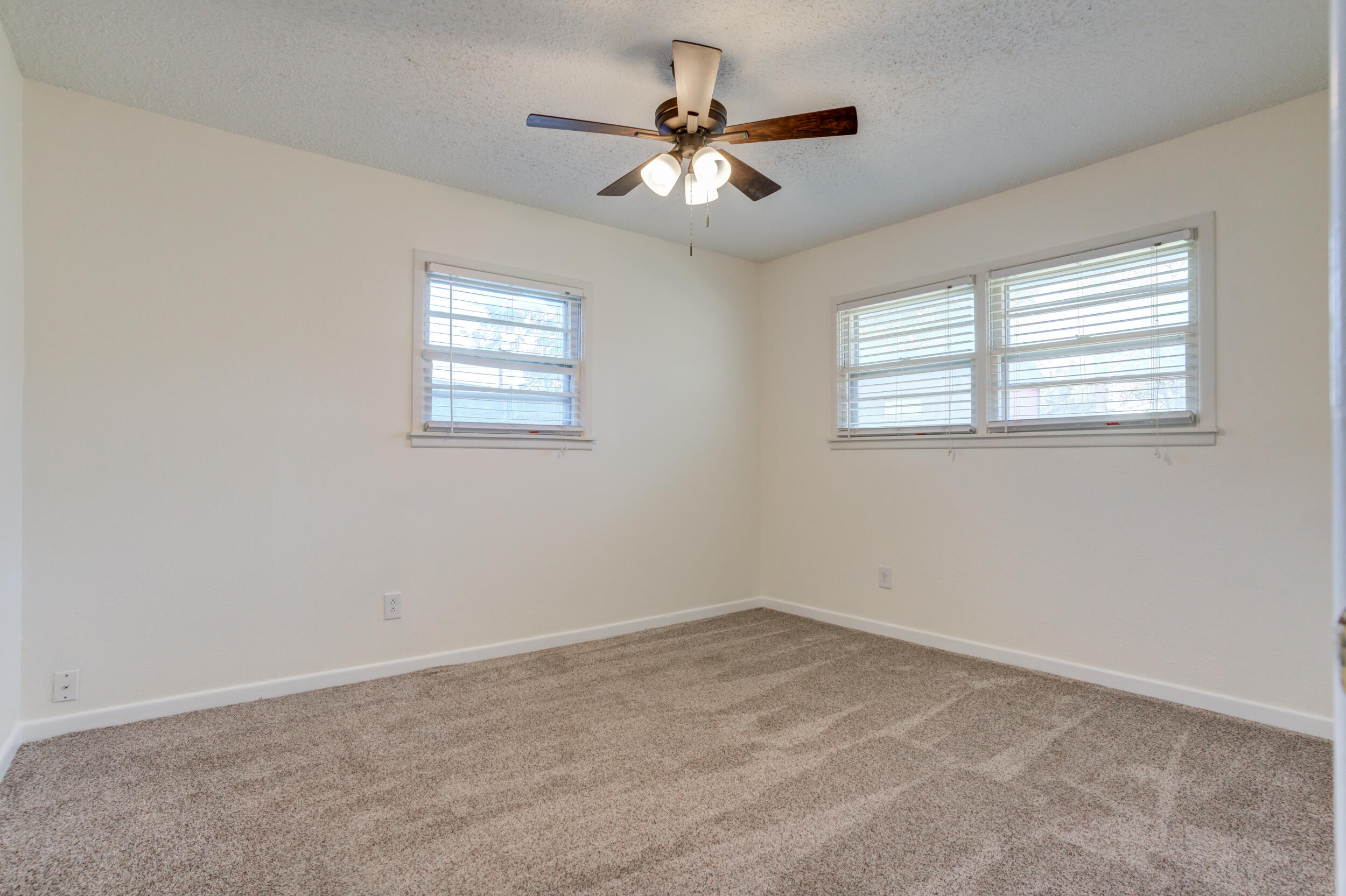 5403 8th Street Lubbock, TX 79416 - Photo 14 of 30 an empty room with a window and a ceiling fan