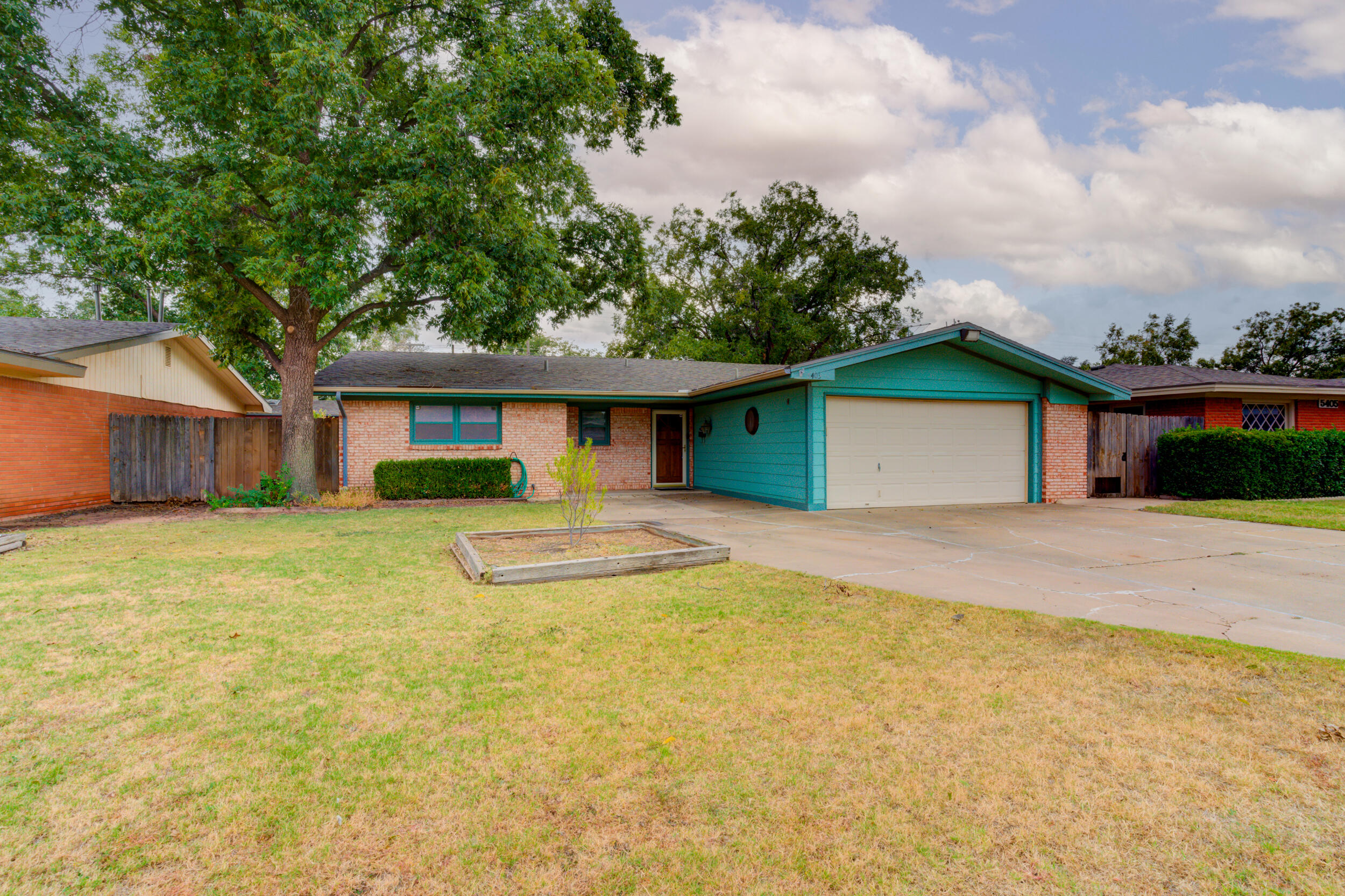 5403 8th Street Lubbock, TX 79416 - Photo 2 of 30 a front view of a house with a yard and garage