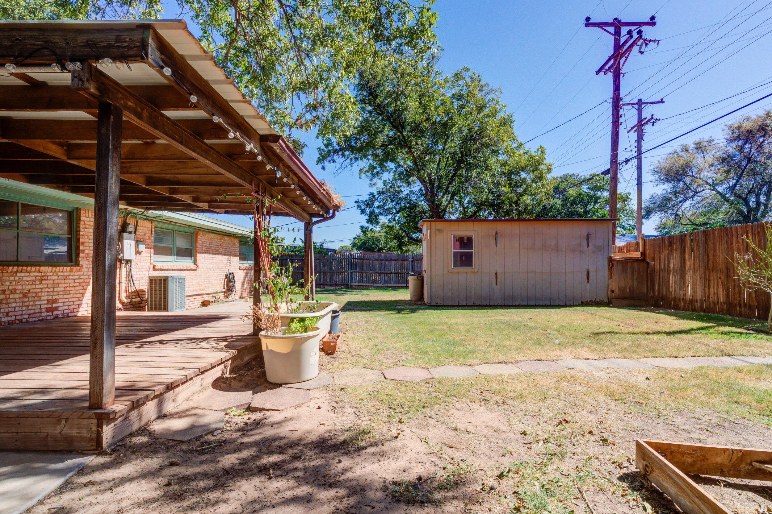 5403 8th Street Lubbock, TX 79416 - Photo 24 of 30 a backyard of a house with basket ball court and outdoor seating
