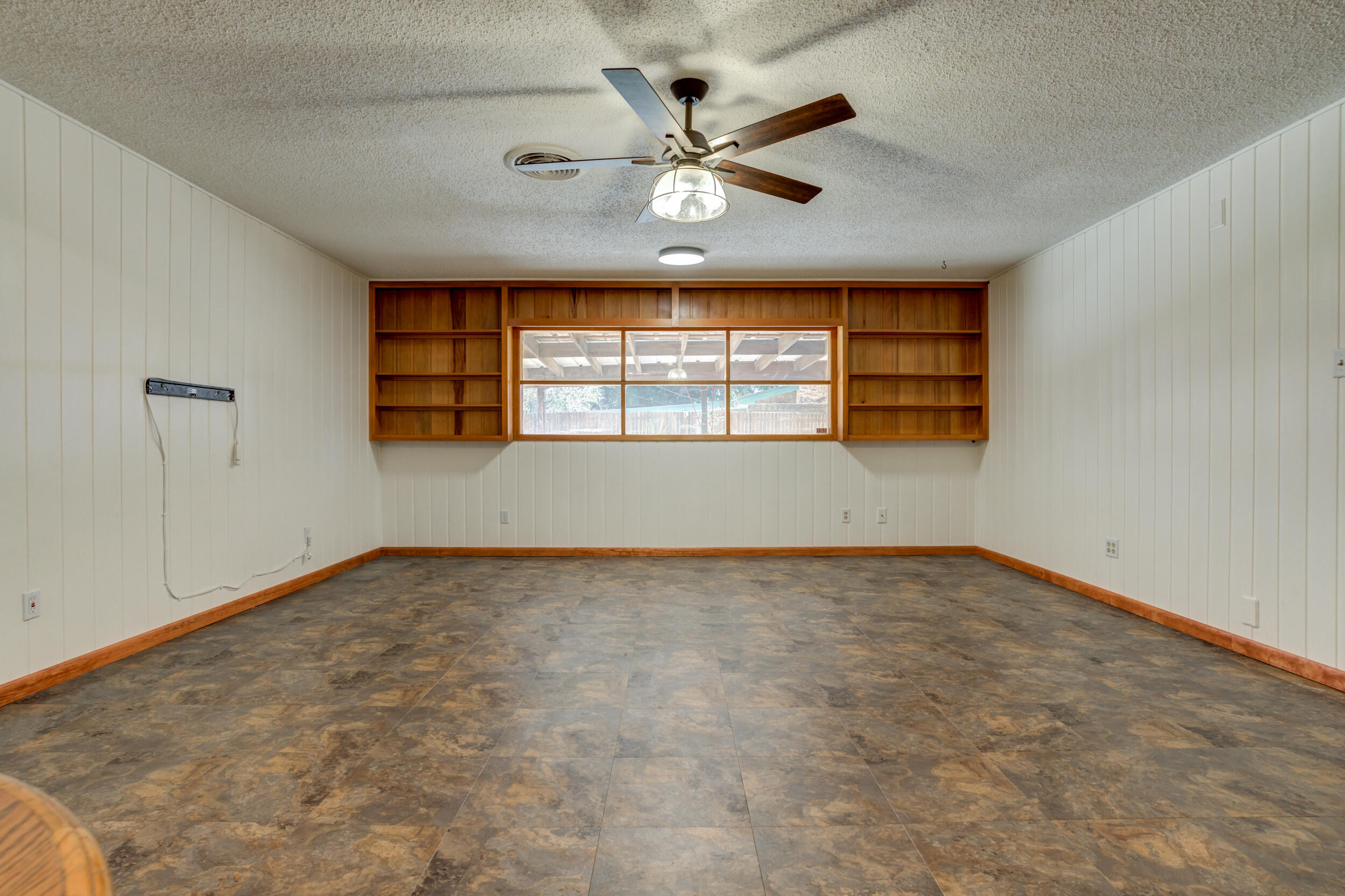 5403 8th Street Lubbock, TX 79416 - Photo 4 of 30 an empty room with windows and ceiling fan