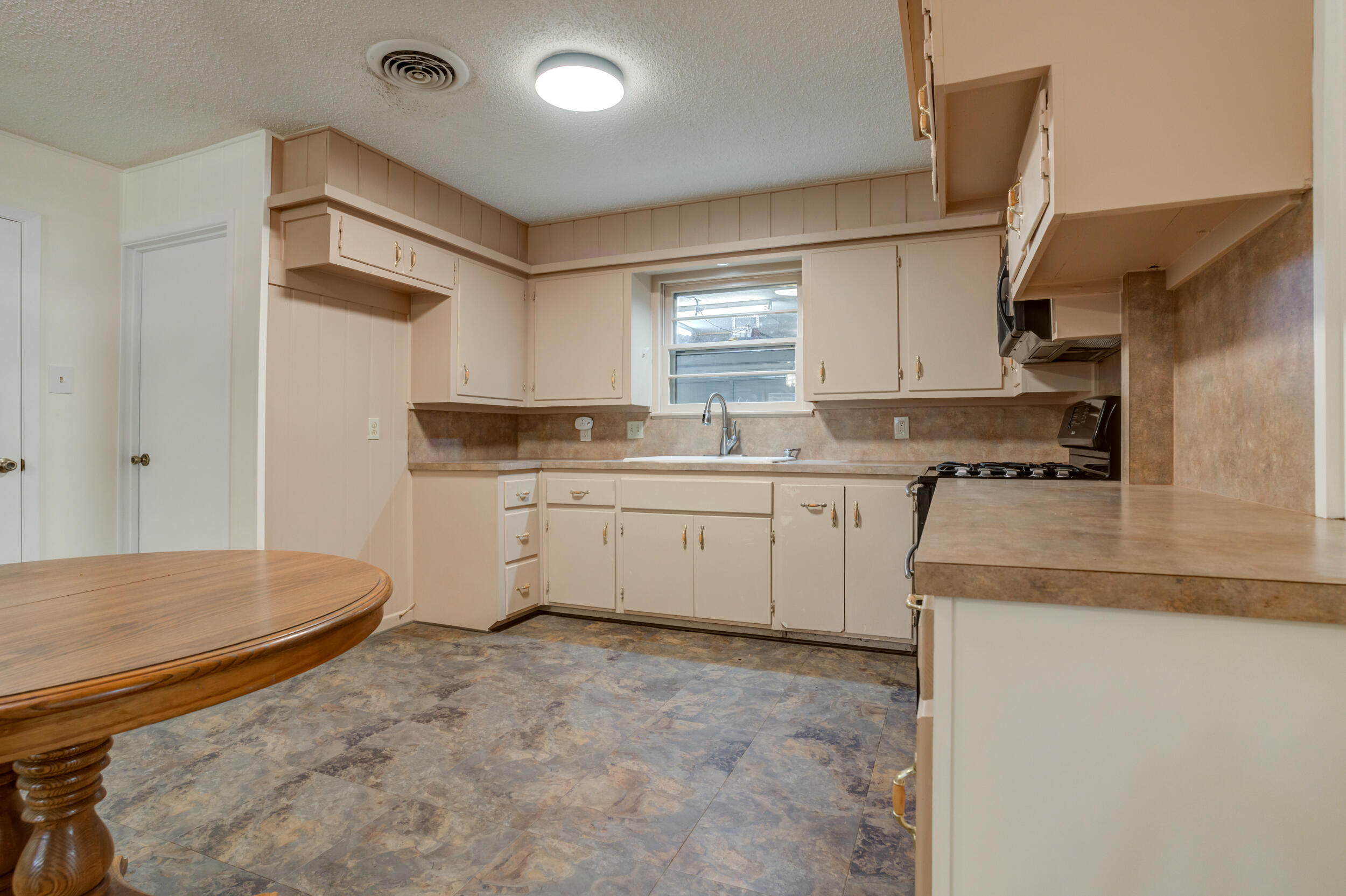 5403 8th Street Lubbock, TX 79416 - Photo 7 of 30 a kitchen with a stove a sink and a refrigerator