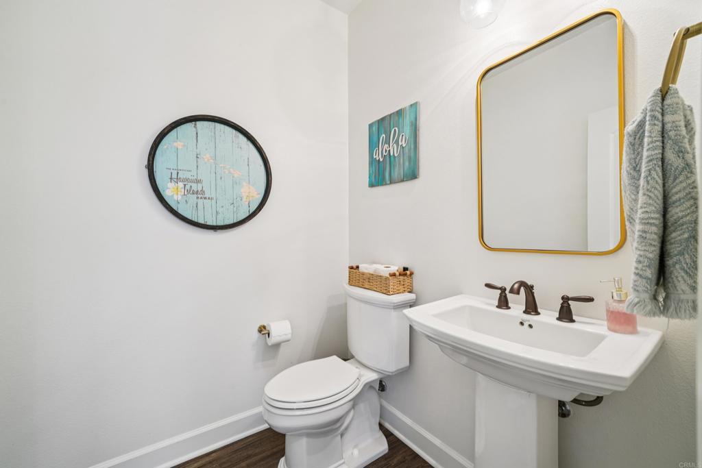 33294 Barmetta Lane Temecula, CA 92592 - Photo 14 of 36 a bathroom with a toilet sink and mirror