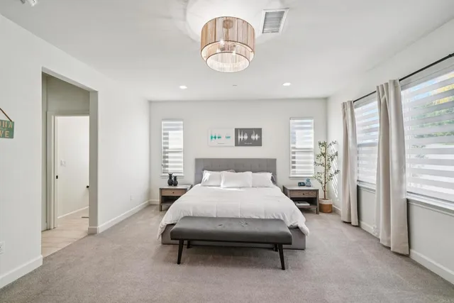 a room with a bed and chandelier