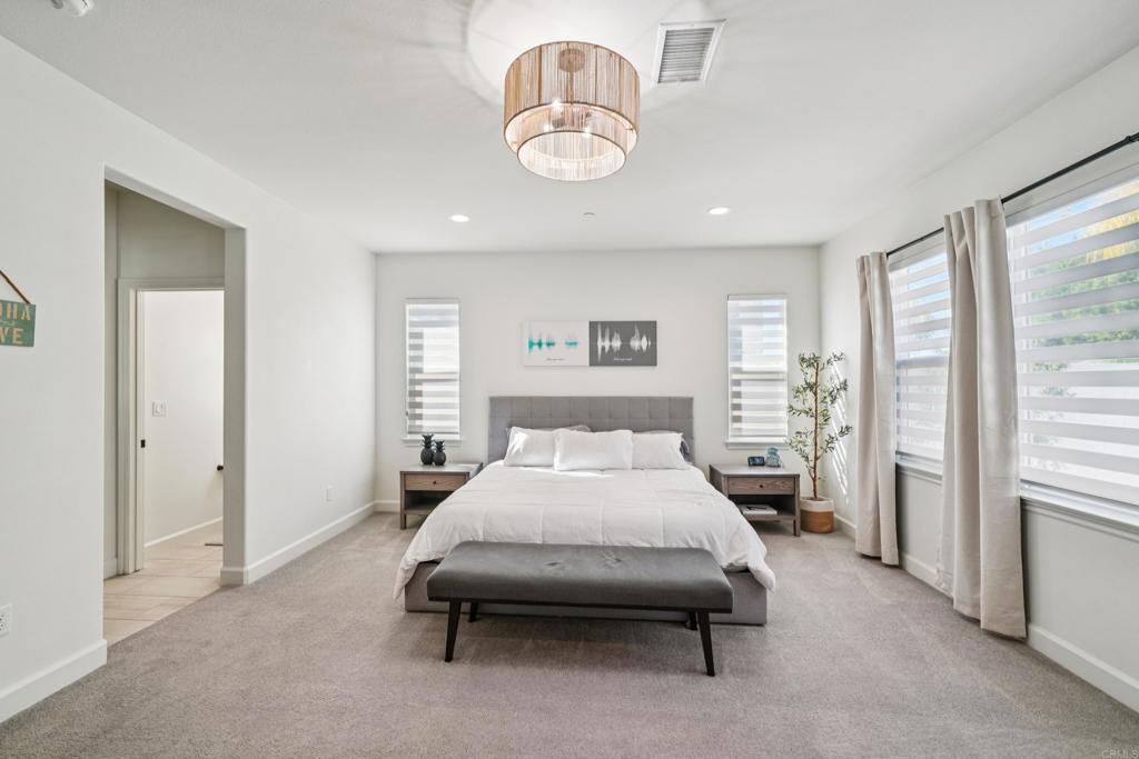 33294 Barmetta Lane Temecula, CA 92592 - Photo 16 of 36 a room with a bed and chandelier