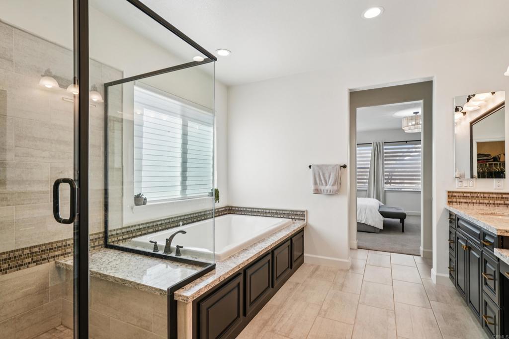 33294 Barmetta Lane Temecula, CA 92592 - Photo 18 of 36 a bathroom with a granite countertop sink and a bathtub