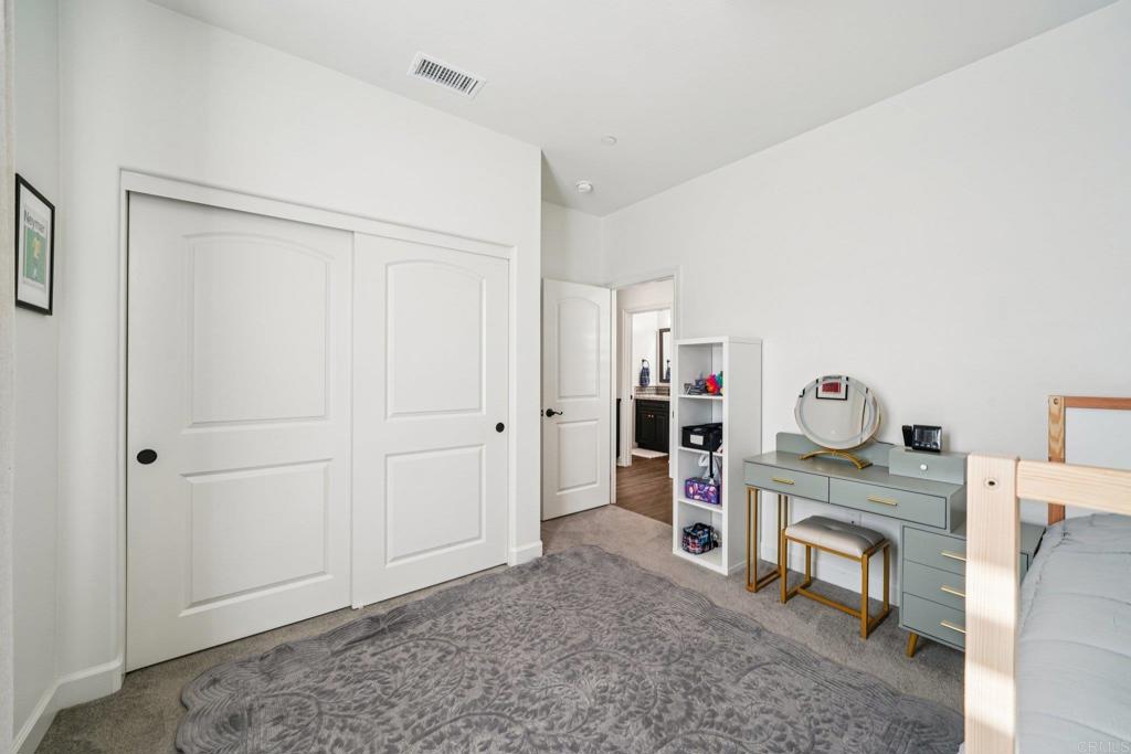 33294 Barmetta Lane Temecula, CA 92592 - Photo 20 of 36 a room that has a bed and a chair in it