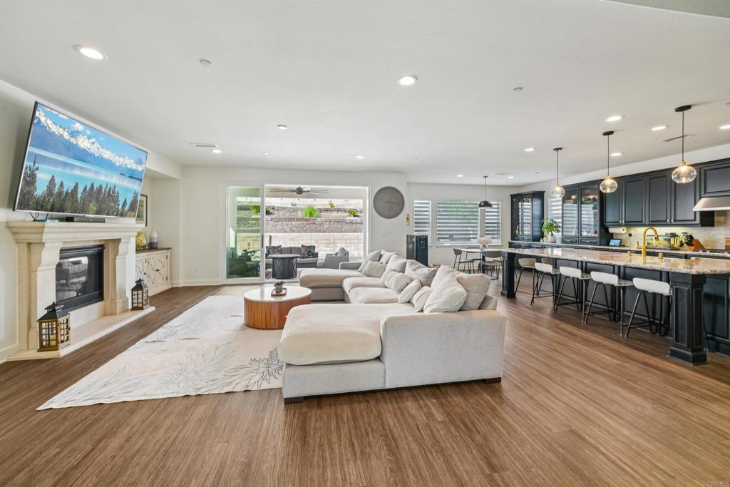 33294 Barmetta Lane Temecula, CA 92592 - Photo 2 of 36 a living room with fireplace furniture and a wooden floor