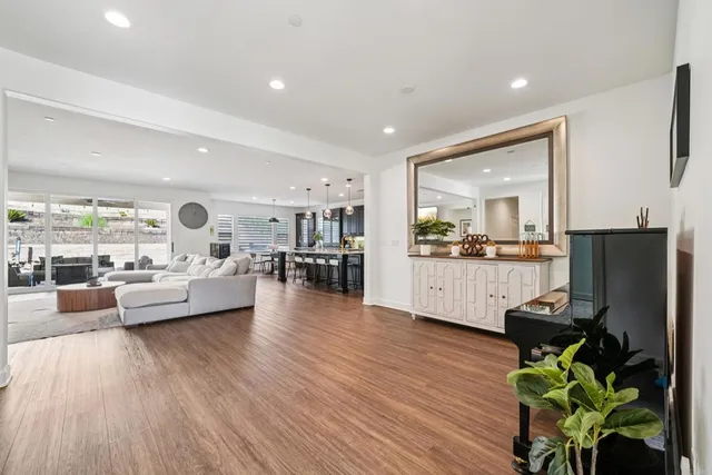 a living room with fireplace furniture and a wooden floor