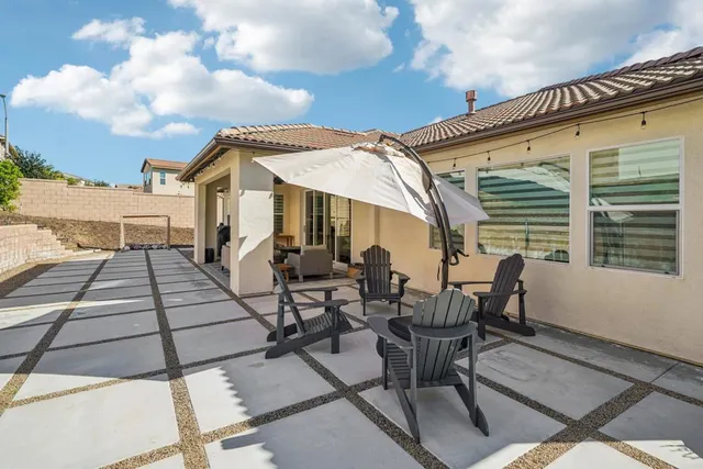 a view of a patio with table and chairs and potted plants