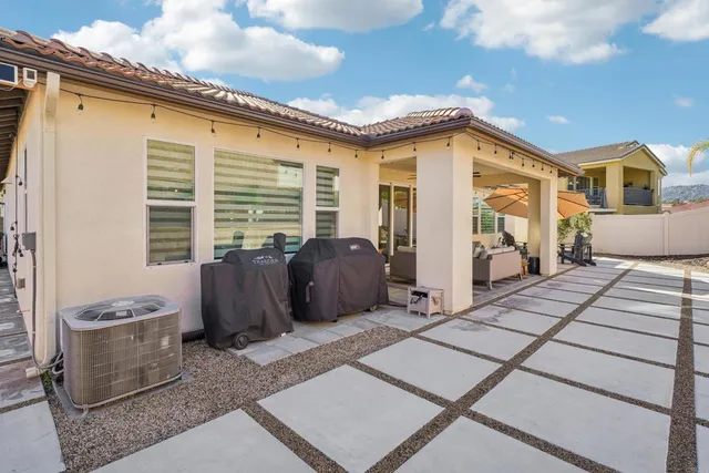 a view of a patio with couches chairs and potted plants