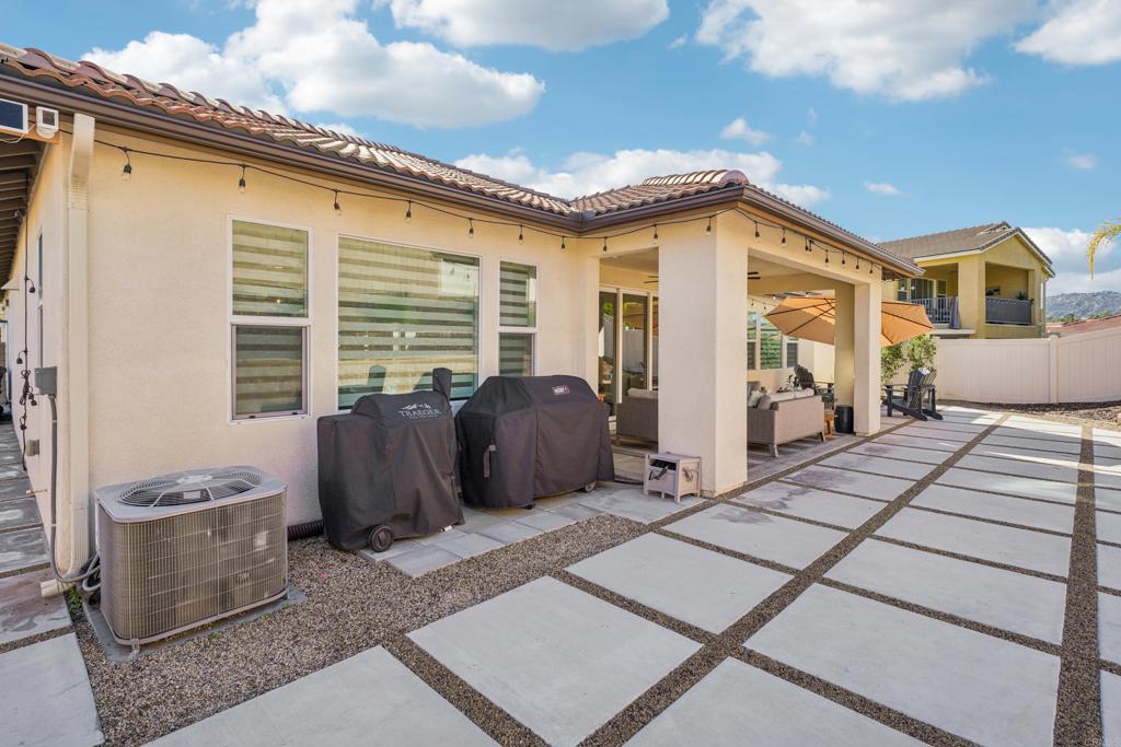 33294 Barmetta Lane Temecula, CA 92592 - Photo 29 of 36 a view of a patio with couches chairs and potted plants