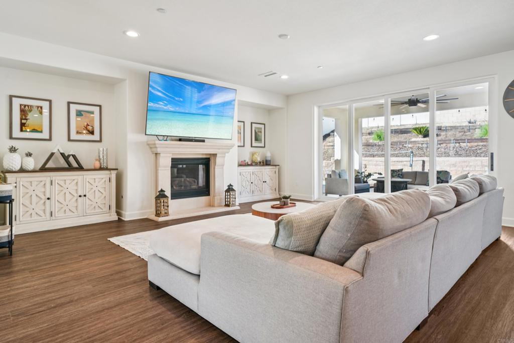 33294 Barmetta Lane Temecula, CA 92592 - Photo 3 of 36 a living room with furniture a fireplace and a flat screen tv