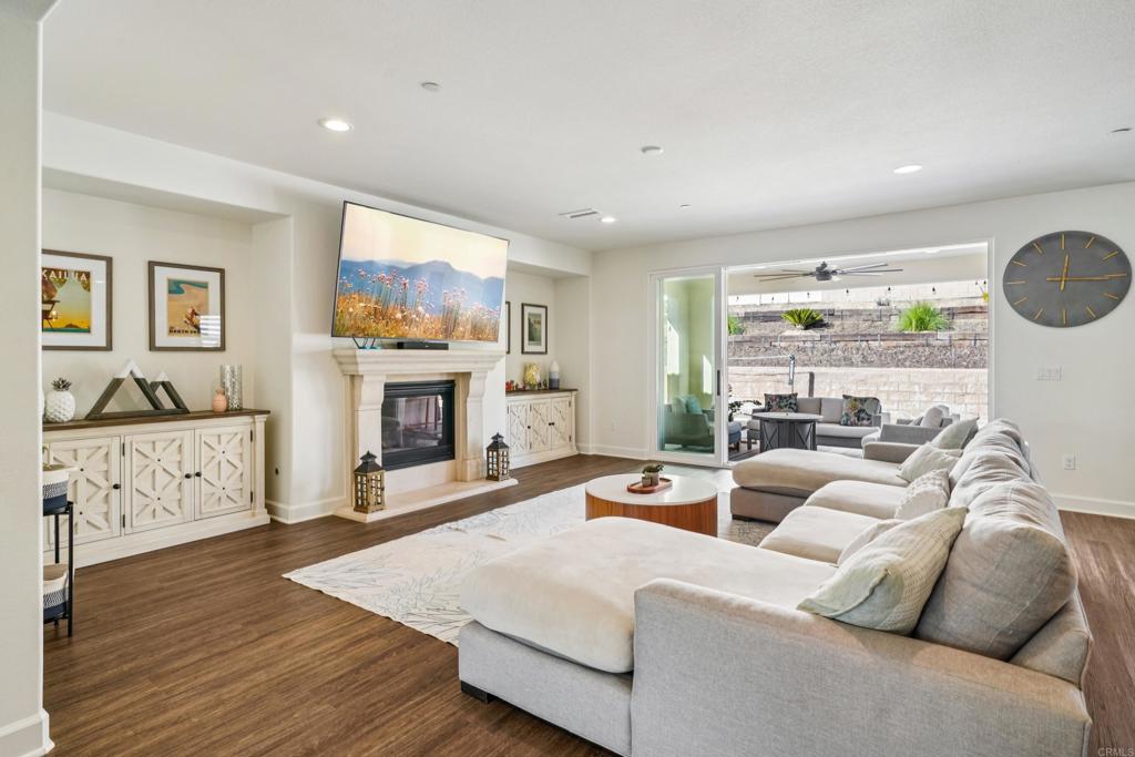 33294 Barmetta Lane Temecula, CA 92592 - Photo 5 of 36 a living room with furniture a fireplace and a large window