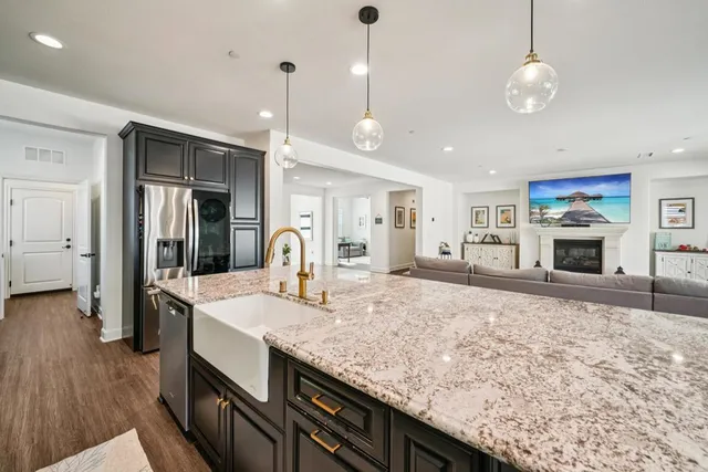 a large kitchen with granite countertop a stove oven and a sink with granite countertops