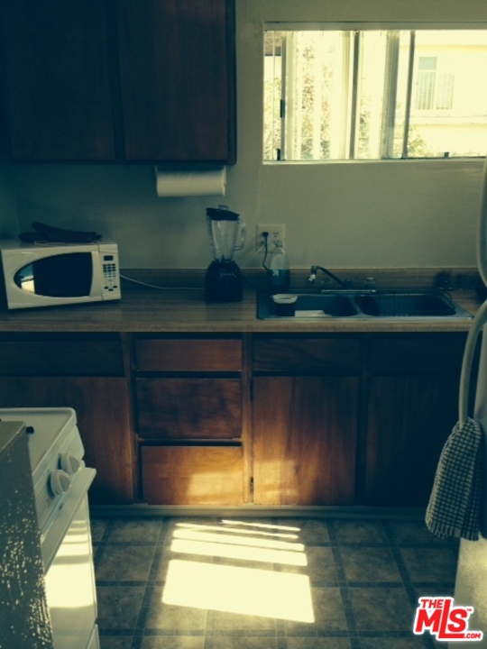3154 Curts Avenue Los Angeles, CA 90034 - Photo 12 of 13 a kitchen with a fridge and wooden floor