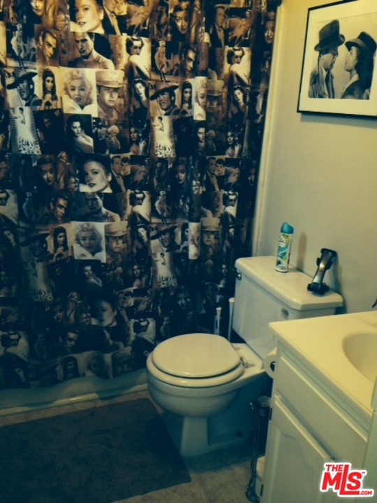 3154 Curts Avenue Los Angeles, CA 90034 - Photo 13 of 13 a white toilet sitting next to a bathroom sink and a rug