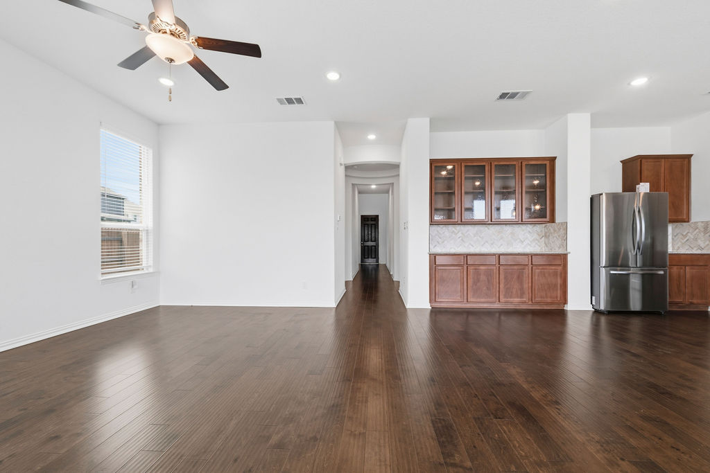 1005 Ridge Runner Drive Georgetown, TX 78628 - Photo 3 of 32 Expansive living area featuring rich wood-finish flooring, recessed lighting, and a ceiling fan