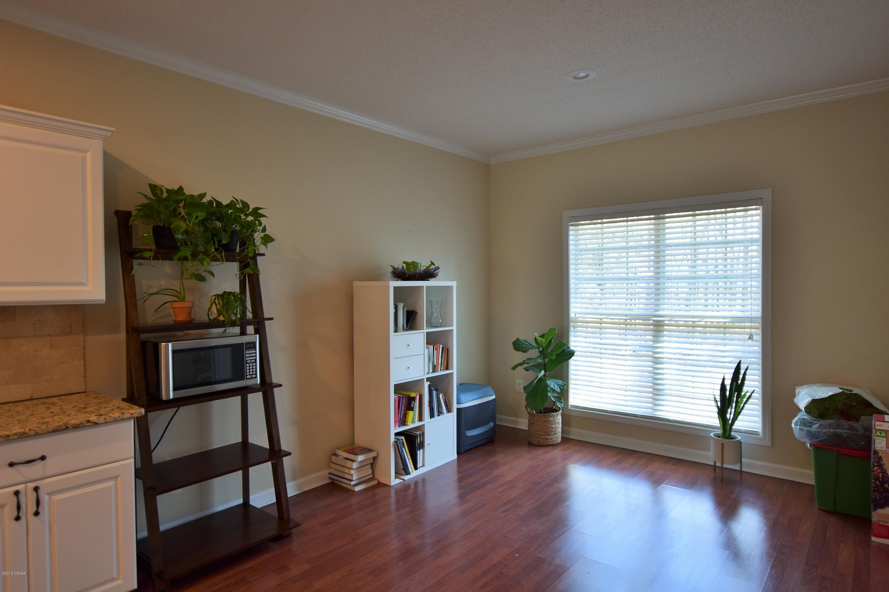 262 Ridge Point Way Macon, GA 31220 - Photo 11 of 27 a view of empty room with wooden floor and fan
