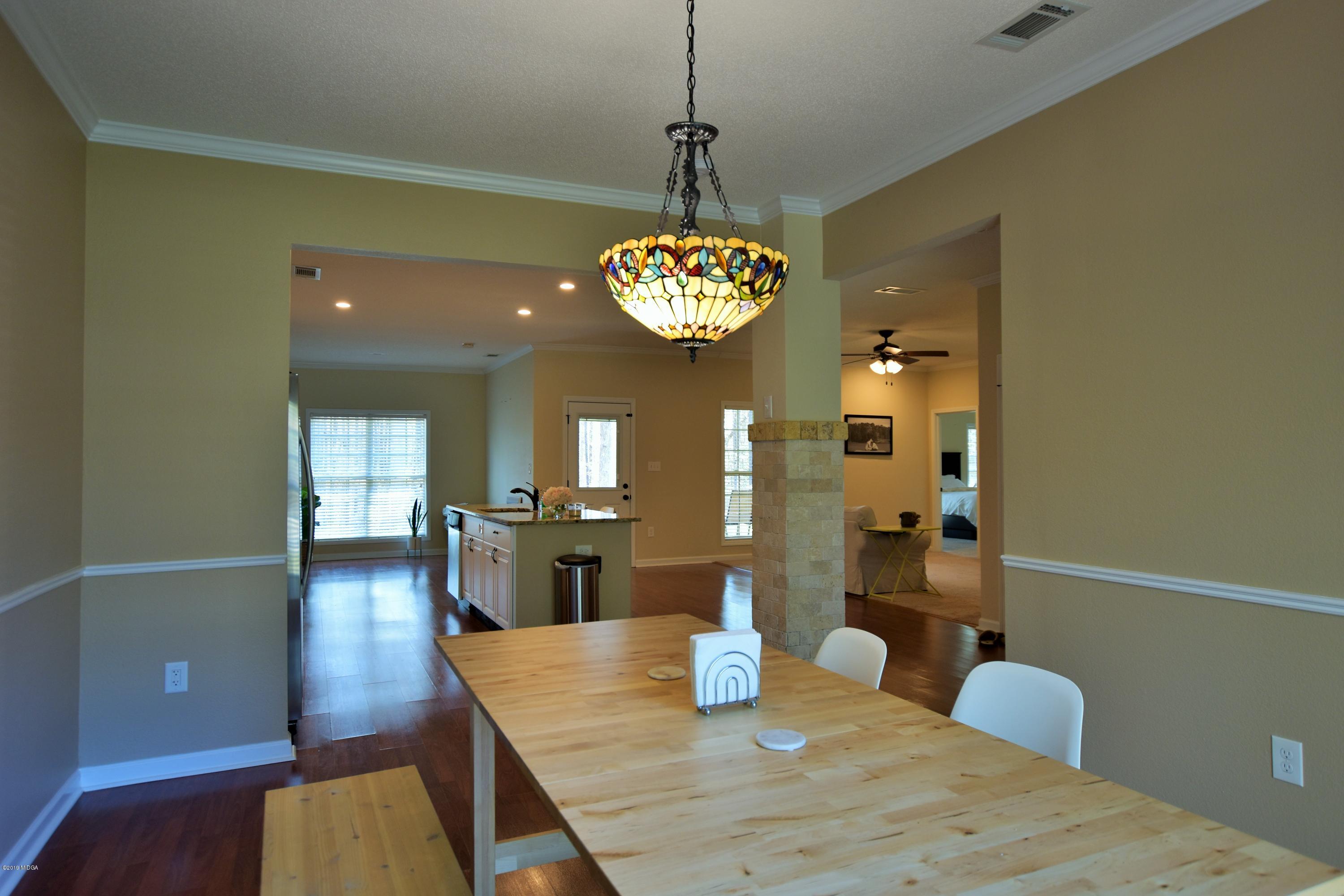 262 Ridge Point Way Macon, GA 31220 - Photo 13 of 27 a view of a dining room with furniture and wooden floor