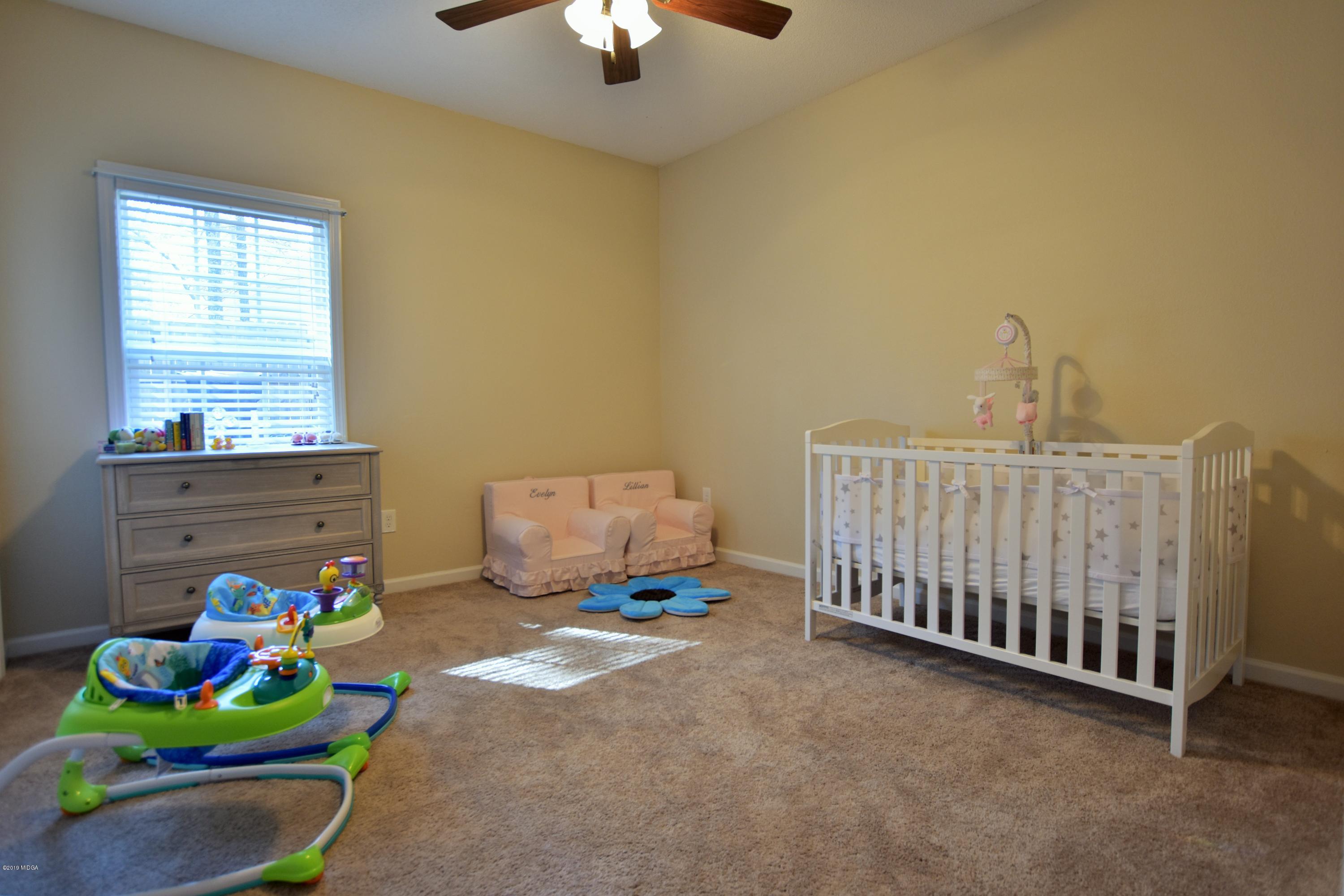 262 Ridge Point Way Macon, GA 31220 - Photo 15 of 27 a bedroom with a bed and a window