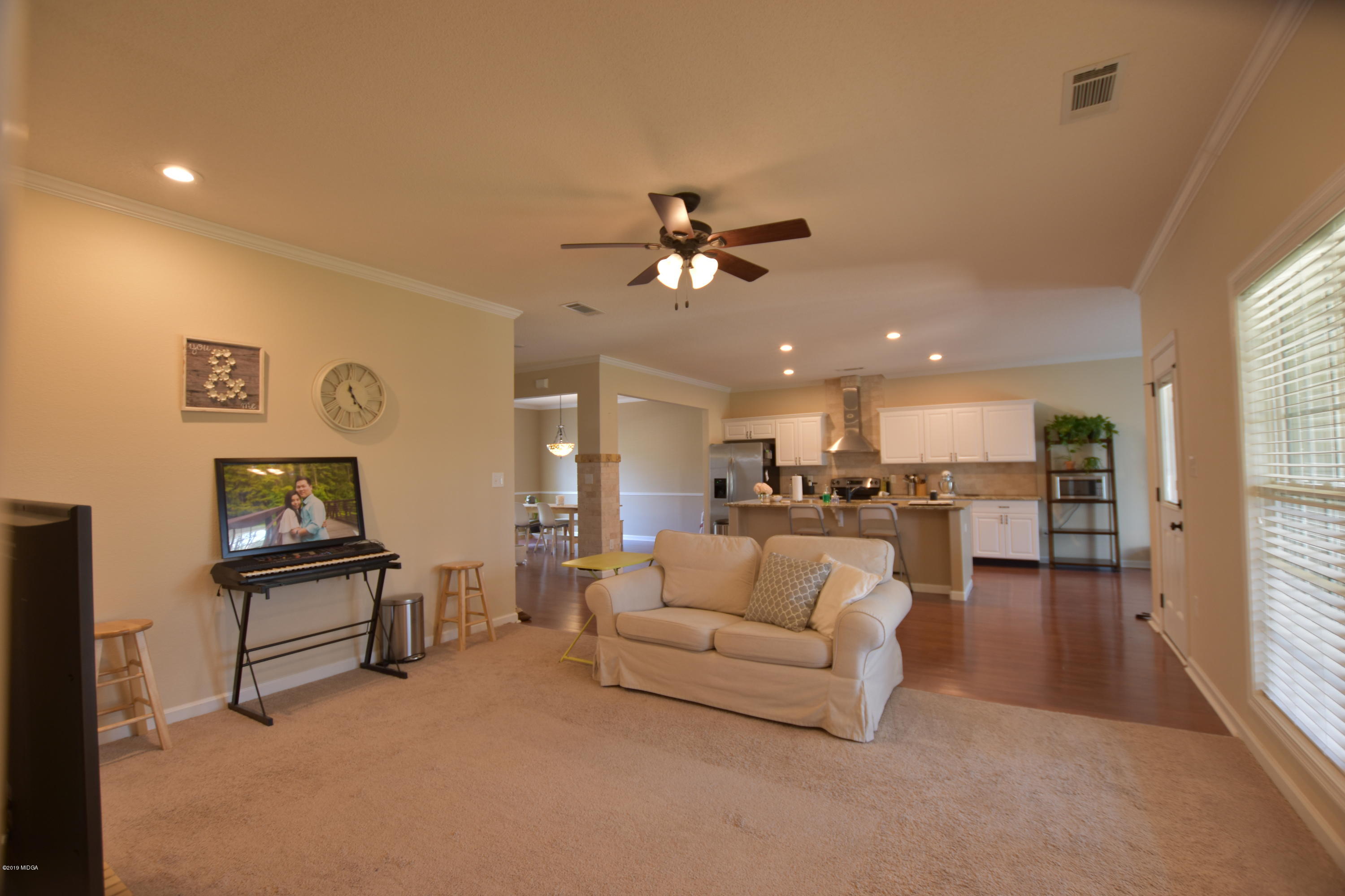 262 Ridge Point Way Macon, GA 31220 - Photo 17 of 27 a living room with furniture and a chandelier