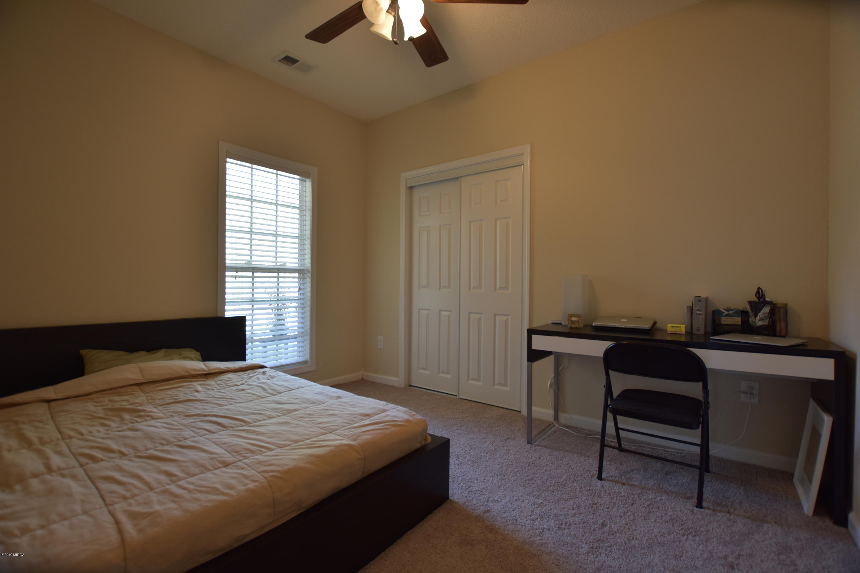 262 Ridge Point Way Macon, GA 31220 - Photo 19 of 27 a bedroom with a bed and a chandelier