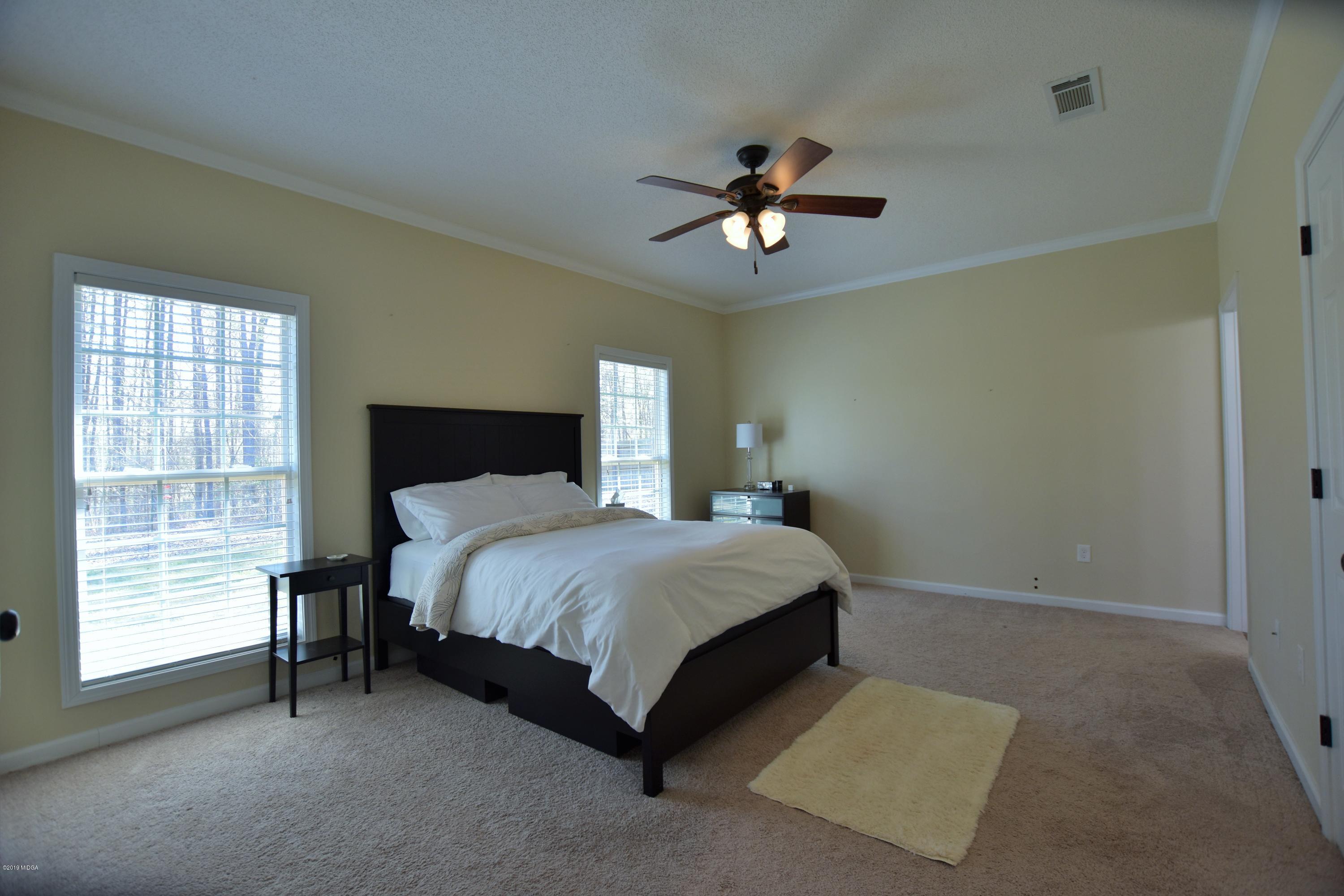 262 Ridge Point Way Macon, GA 31220 - Photo 22 of 27 a spacious bedroom with a bed and a window