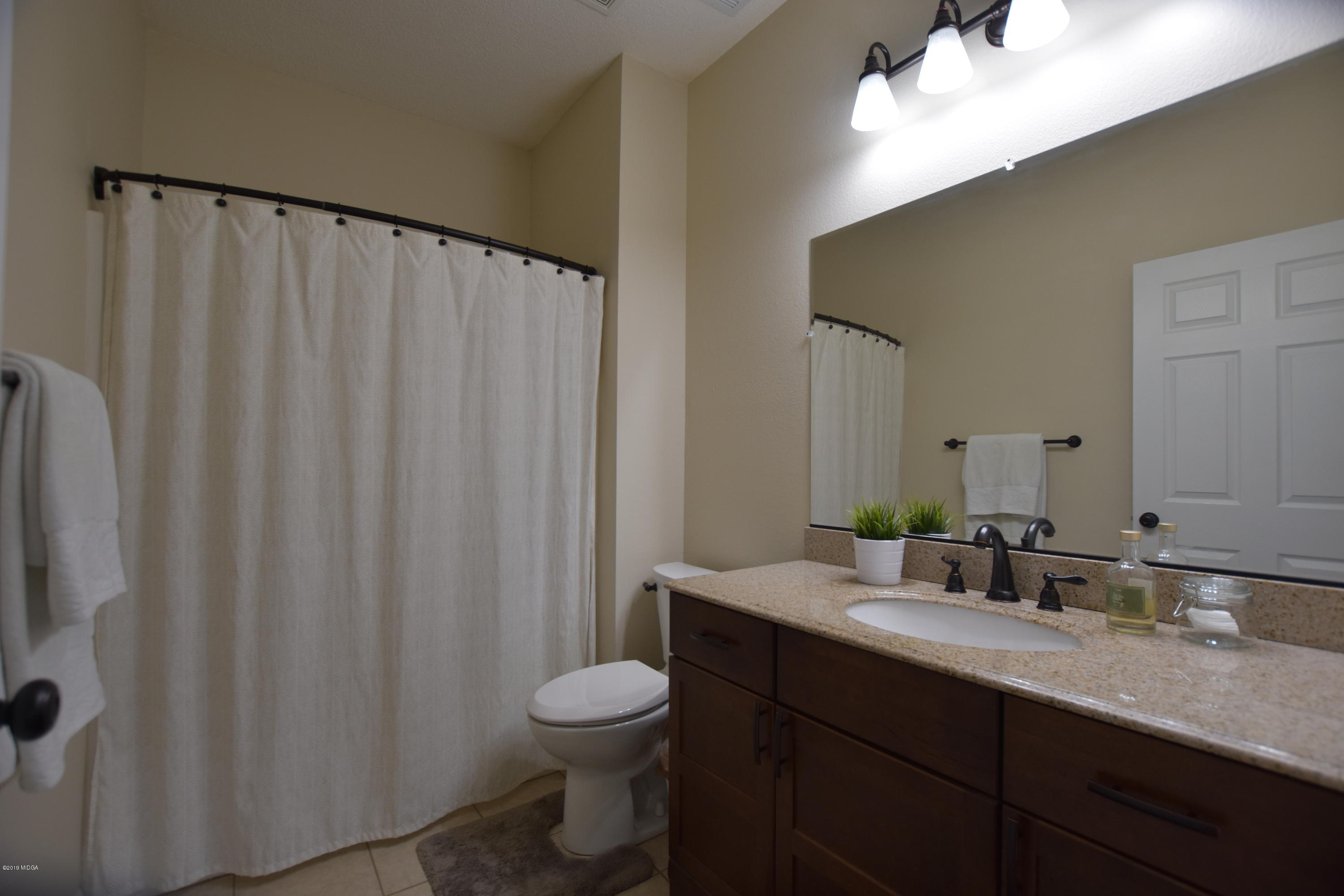 262 Ridge Point Way Macon, GA 31220 - Photo 23 of 27 a bathroom with a double vanity sink toilet and a mirror