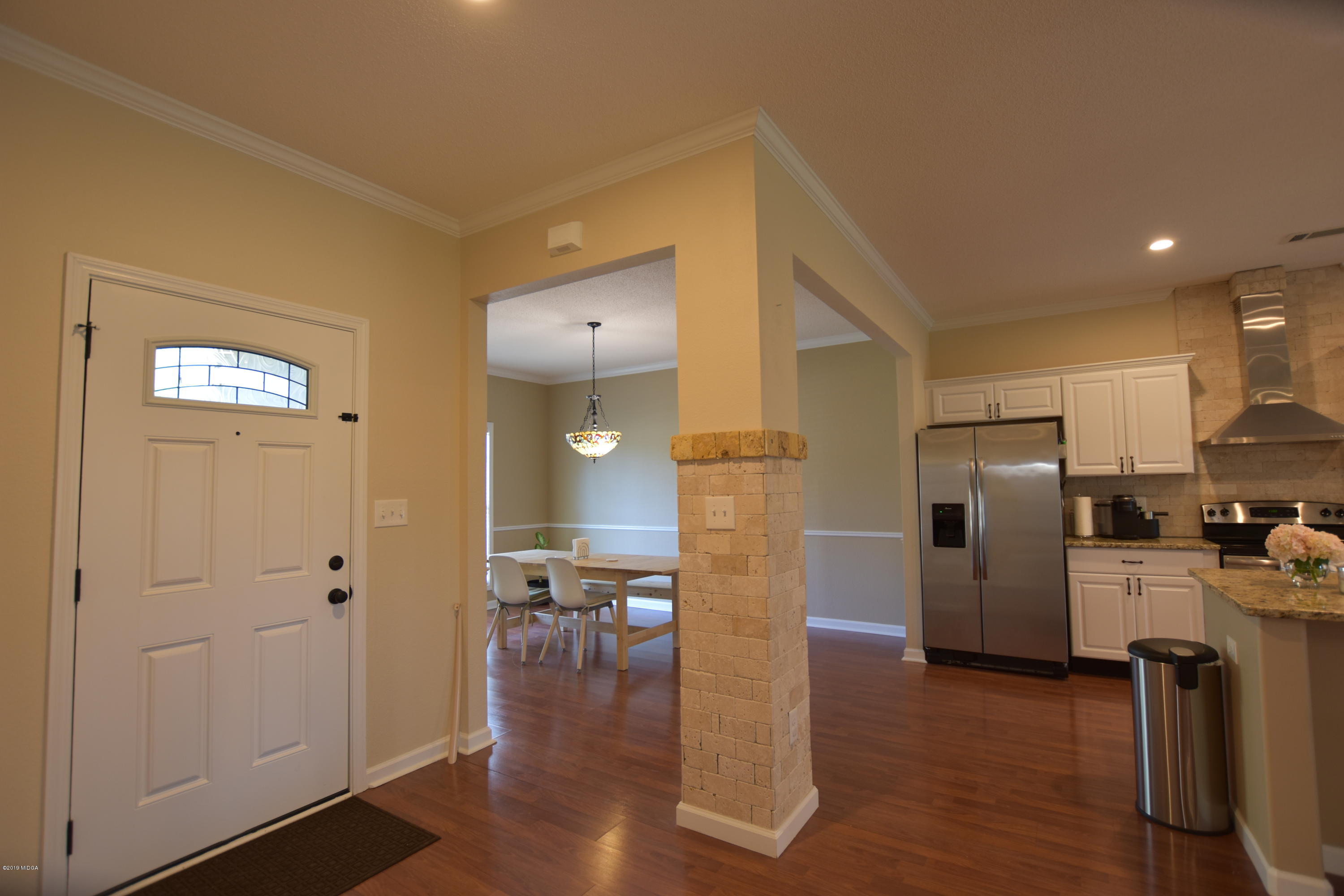 262 Ridge Point Way Macon, GA 31220 - Photo 4 of 27 a kitchen with stainless steel appliances a refrigerator and wooden floor