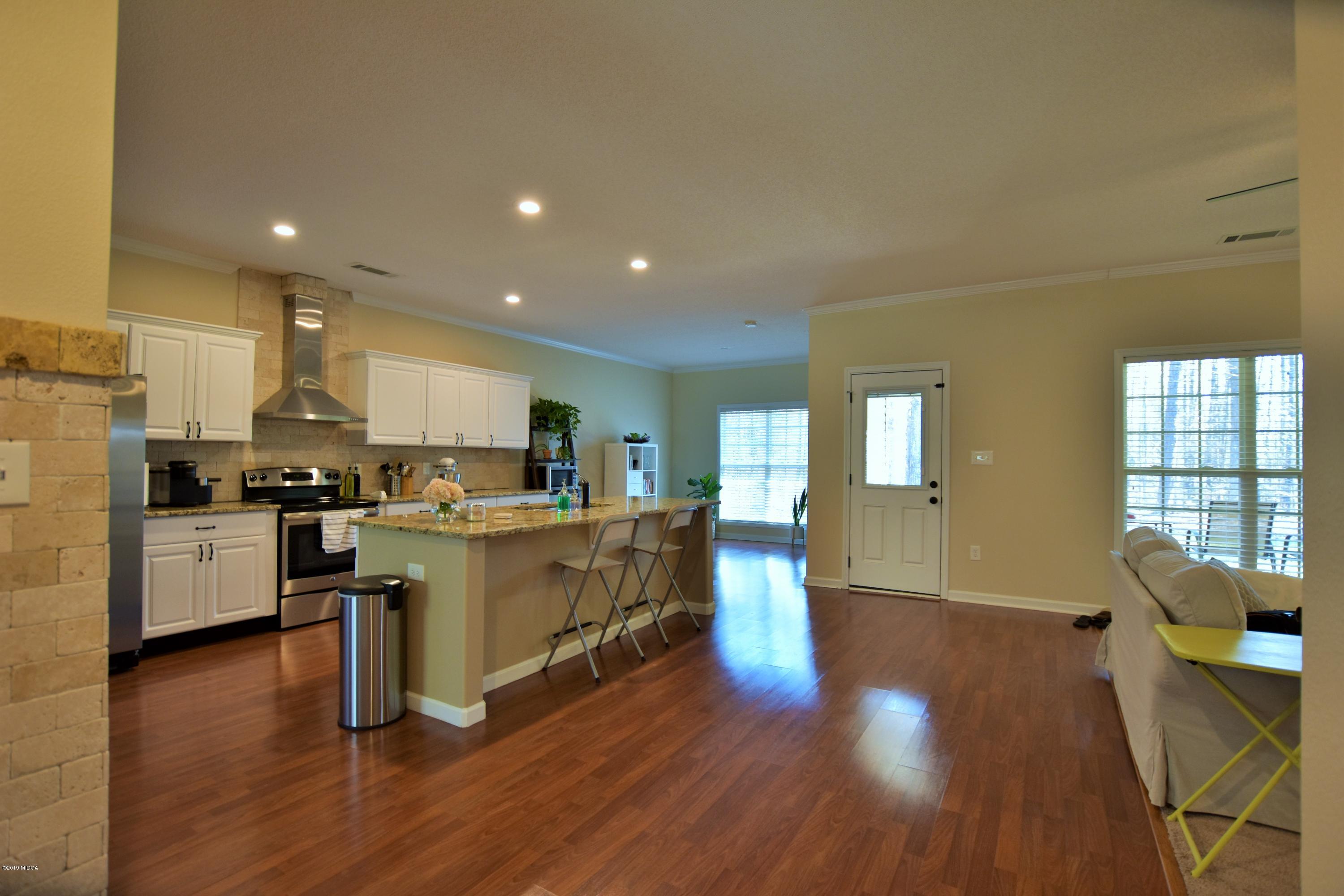 262 Ridge Point Way Macon, GA 31220 - Photo 5 of 27 a kitchen with a sink wooden floor stainless steel appliances and cabinets