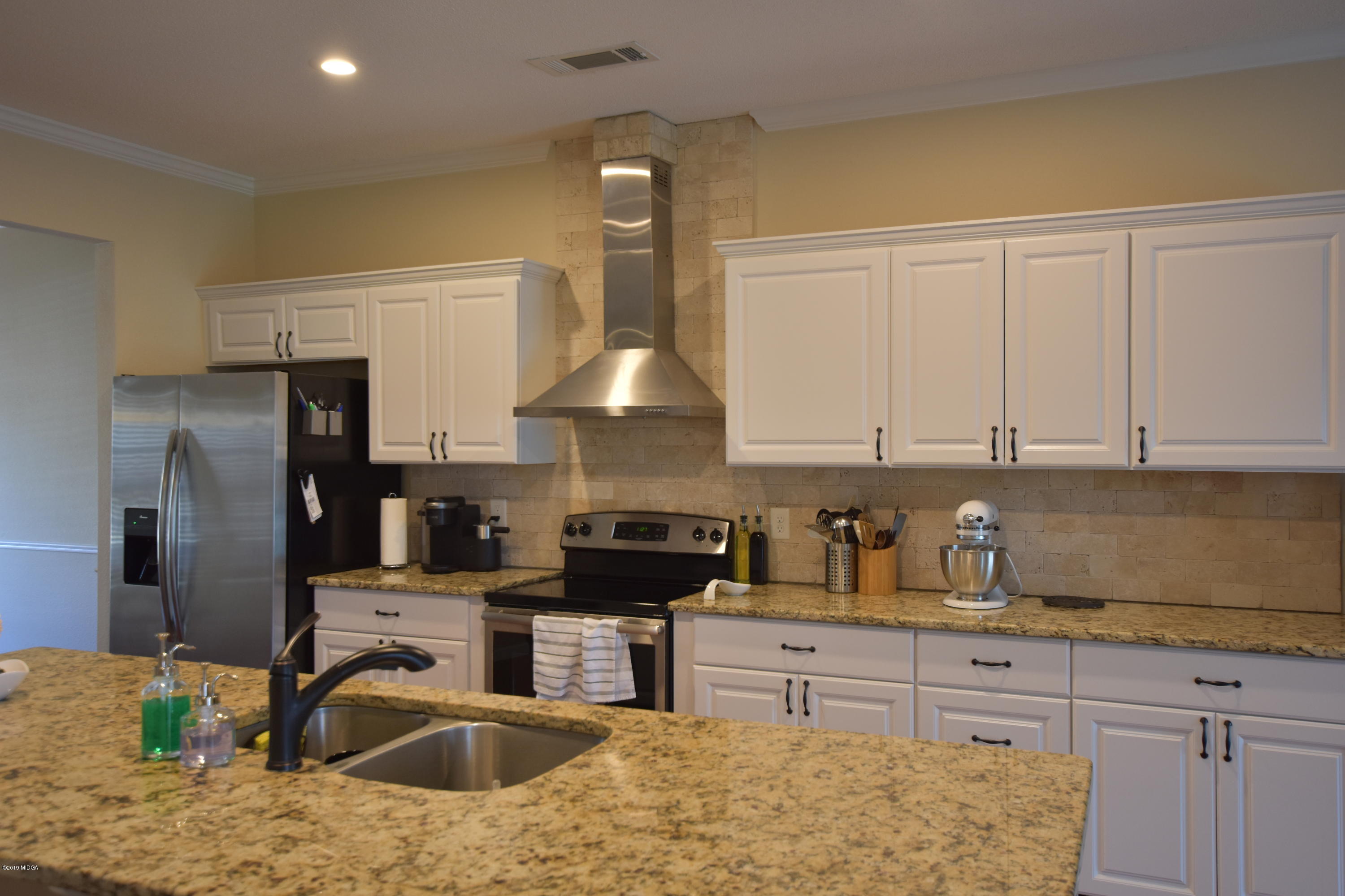 262 Ridge Point Way Macon, GA 31220 - Photo 8 of 27 a kitchen with stainless steel appliances granite countertop a sink stove and refrigerator