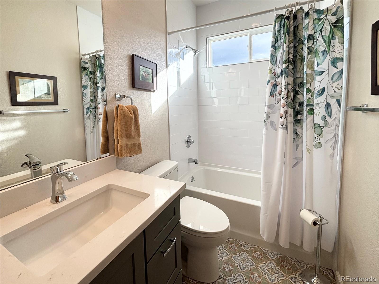6060 Deframe Court Arvada, CO 80004 - Photo 17 of 45 a bathroom with a sink toilet and shower