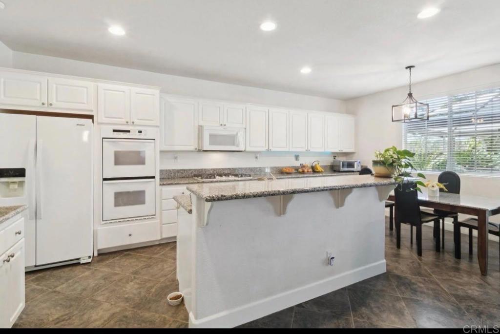 1234 Old Janal Ranch Road Chula Vista, CA 91915 - Photo 17 of 34 a kitchen with stainless steel appliances granite countertop a refrigerator sink and cabinets