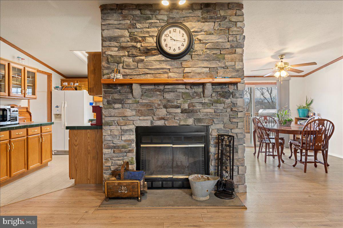 230 Cedar Flat Road Warfordsburg, PA 17267 - Photo 18 of 44 a living room with furniture a clock and a fireplace