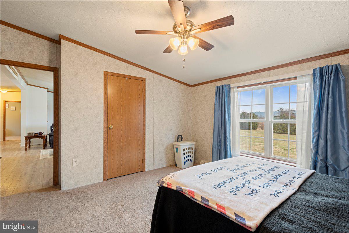 230 Cedar Flat Road Warfordsburg, PA 17267 - Photo 27 of 44 a view of a livingroom with wooden floor and a ceiling fan