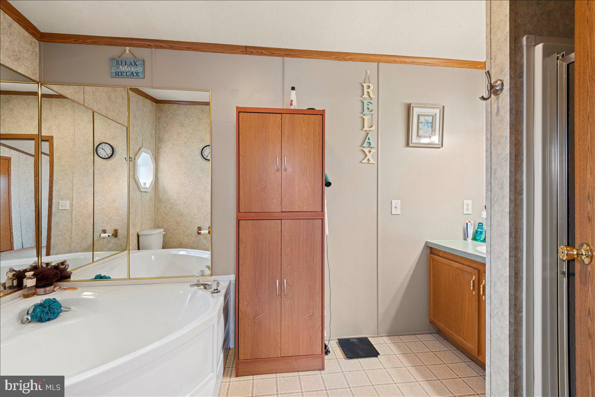 230 Cedar Flat Road Warfordsburg, PA 17267 - Photo 28 of 44 a bathroom with a tub sink and mirror