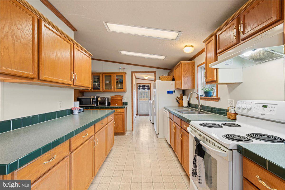 230 Cedar Flat Road Warfordsburg, PA 17267 - Photo 7 of 44 a kitchen with stainless steel appliances a sink stove and cabinets