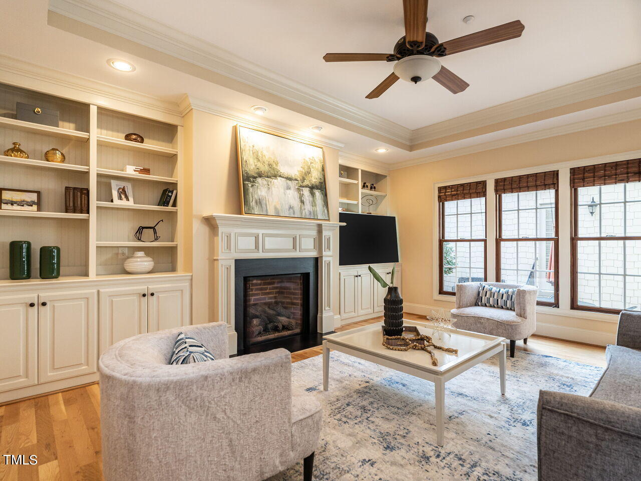 3421 Ebenezer Church Road Raleigh, NC 27612 - Photo 11 of 43 a living room with furniture fireplace and a flat screen tv