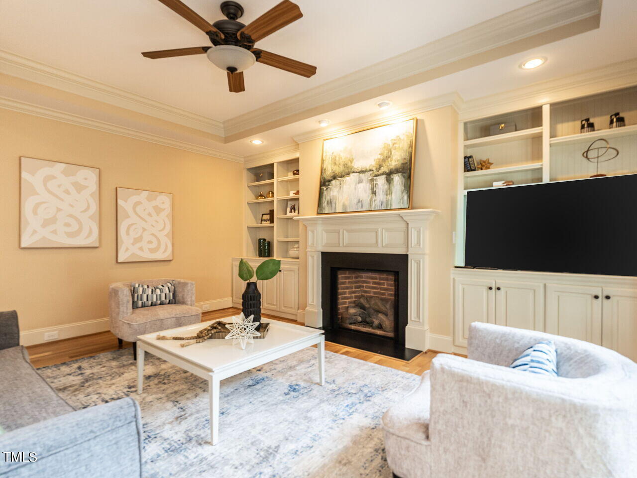3421 Ebenezer Church Road Raleigh, NC 27612 - Photo 13 of 43 a living room with furniture a flat screen tv and a fireplace