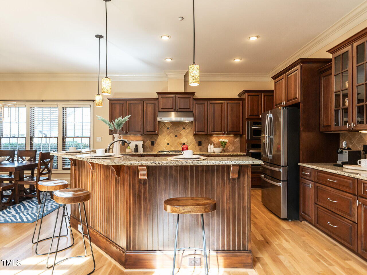 3421 Ebenezer Church Road Raleigh, NC 27612 - Photo 16 of 43 a kitchen with stainless steel appliances granite countertop a sink a stove and a refrigerator