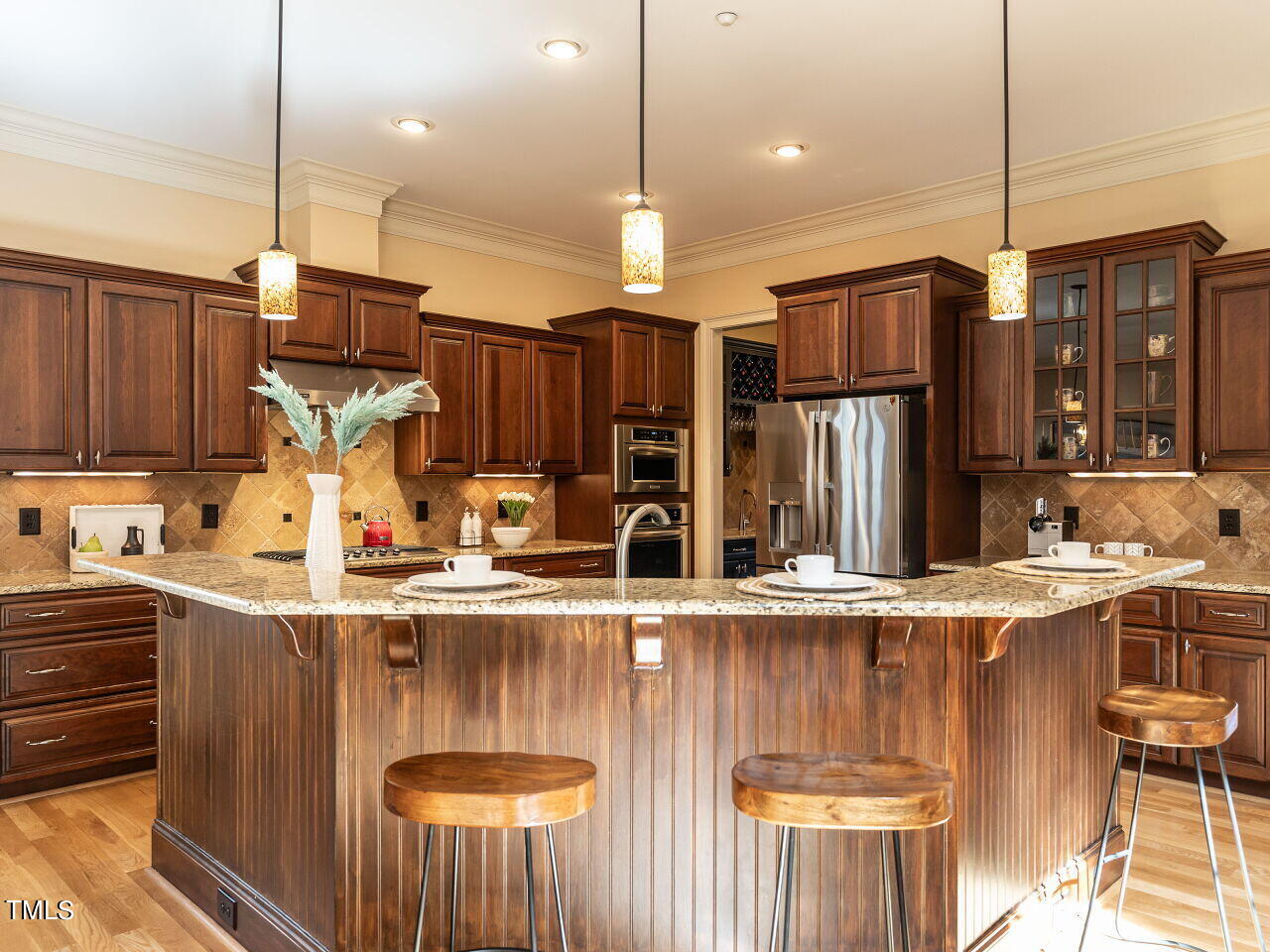 3421 Ebenezer Church Road Raleigh, NC 27612 - Photo 17 of 43 a kitchen with stainless steel appliances granite countertop a sink a stove and a refrigerator