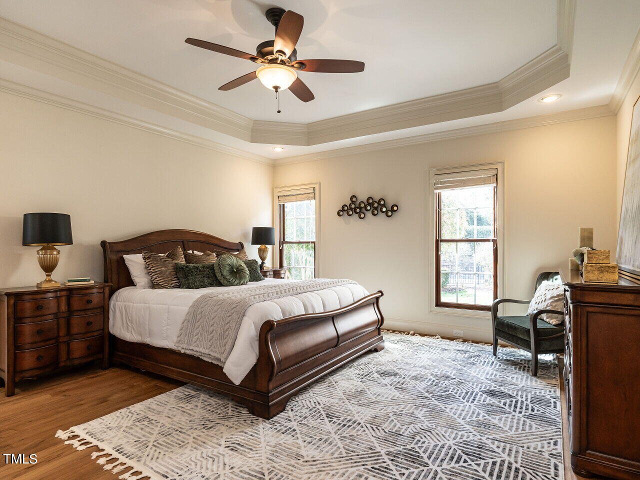 3421 Ebenezer Church Road Raleigh, NC 27612 - Photo 23 of 43 a spacious bedroom with a bed a window and chair