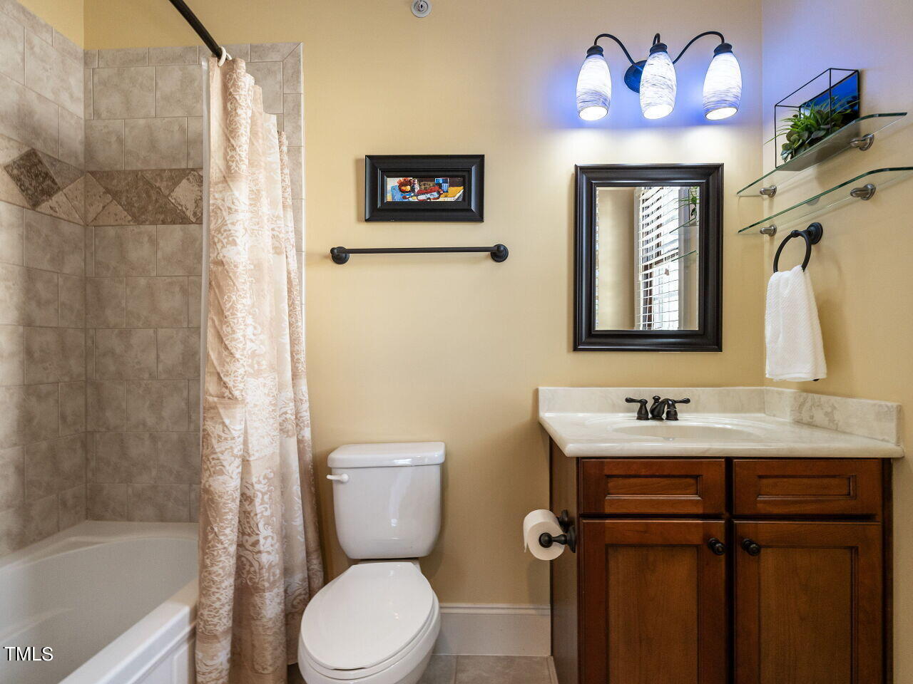 3421 Ebenezer Church Road Raleigh, NC 27612 - Photo 30 of 43 a bathroom with a sink mirror vanity and toilet