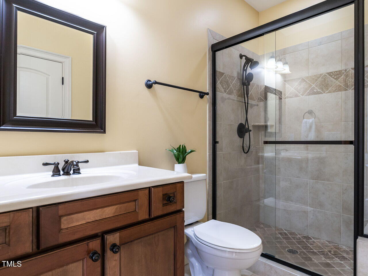 3421 Ebenezer Church Road Raleigh, NC 27612 - Photo 34 of 43 a bathroom with a sink a toilet and shower