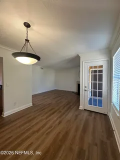 a spacious bathroom with a granite countertop sink a toilet and a mirror