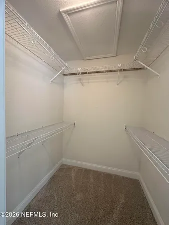 a spacious bathroom with a granite countertop sink a toilet and a mirror