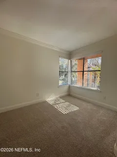 a living room with furniture gym equipment and a large window